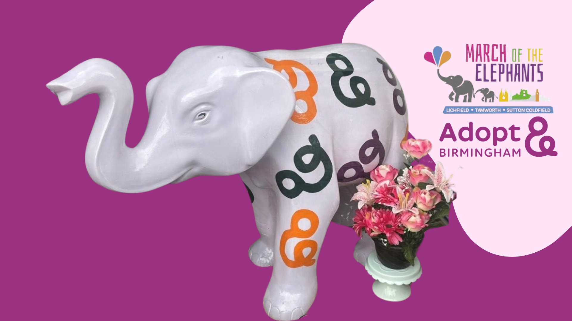 Photo of lilac elephant with pattern of ampersands in orange, purple and green