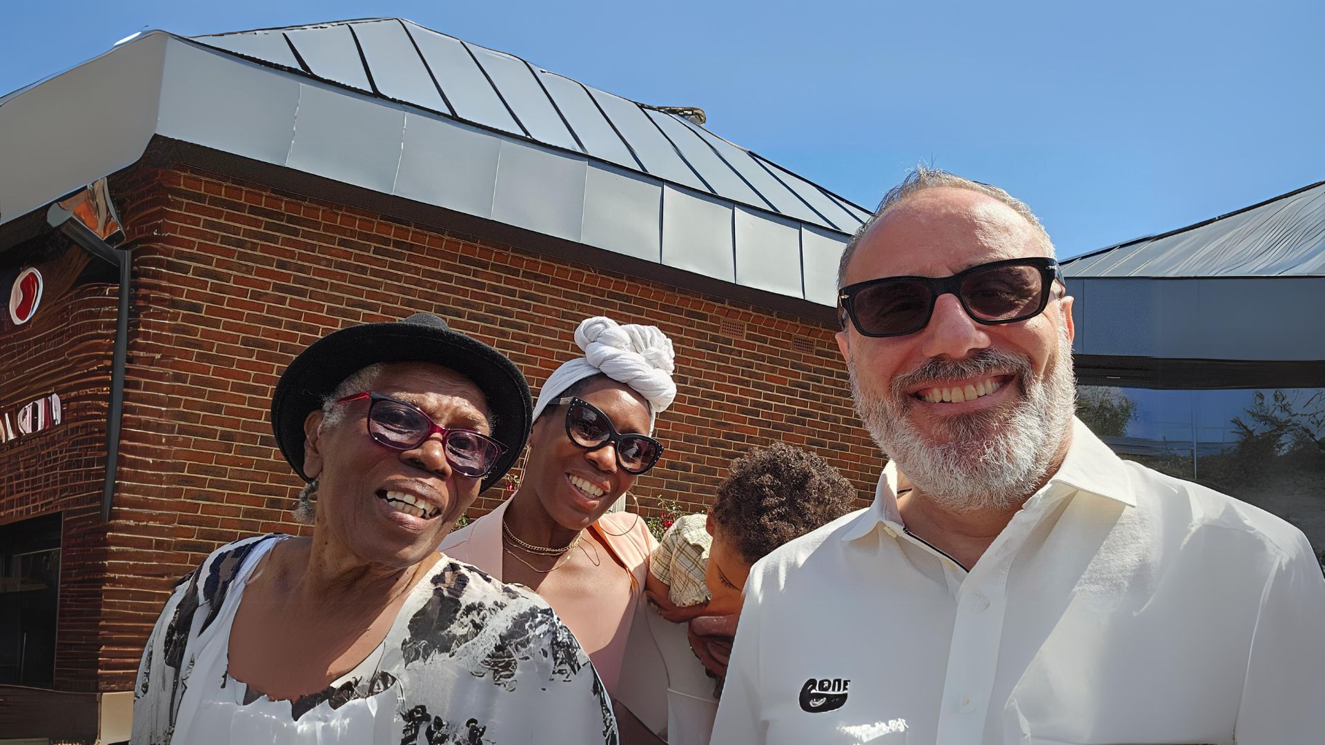 Family smiling into the camera in front of church